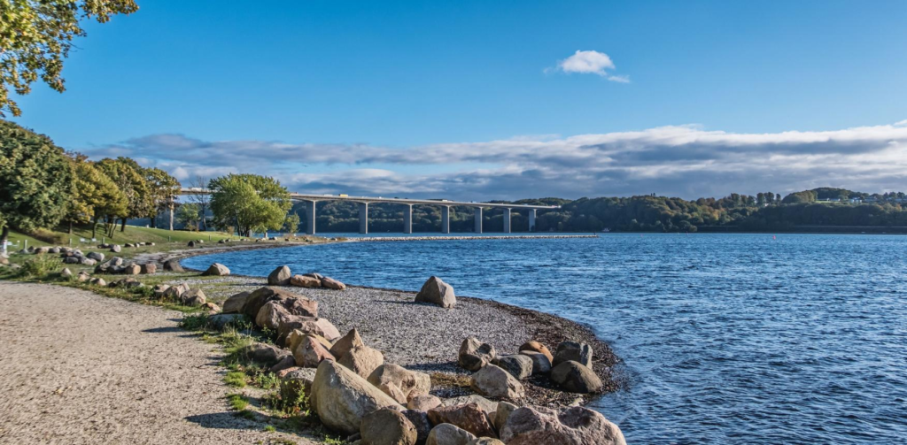 Tourists visiting the Vejle Fjord Bridge with views of the city and surrounding landscape.
