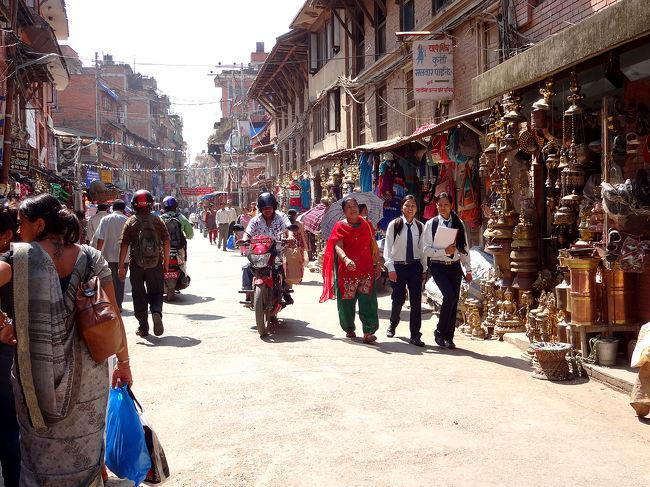 Visitors walking through streets in Lalitpur with local markets, shops, and traditional Newar architecture.