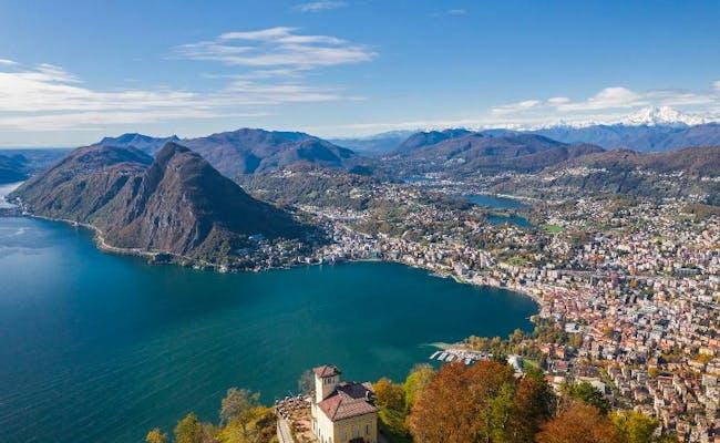 View of Lugano from Monte Brè with city and lake.