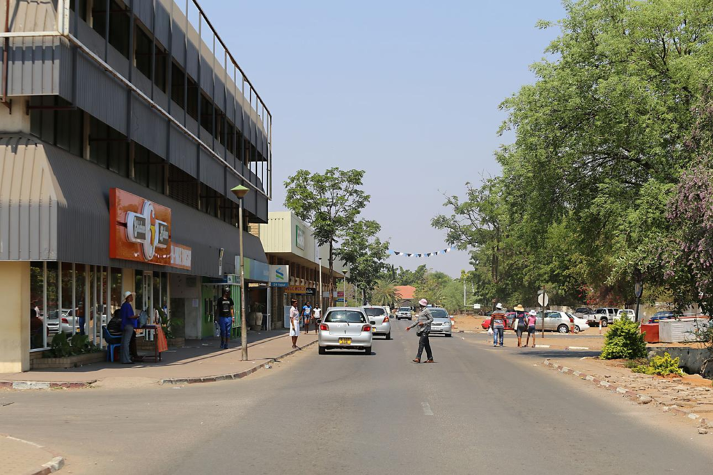 Visitors walking through streets in Selebi-Phikwe with local shops, markets, and pedestrian activity.