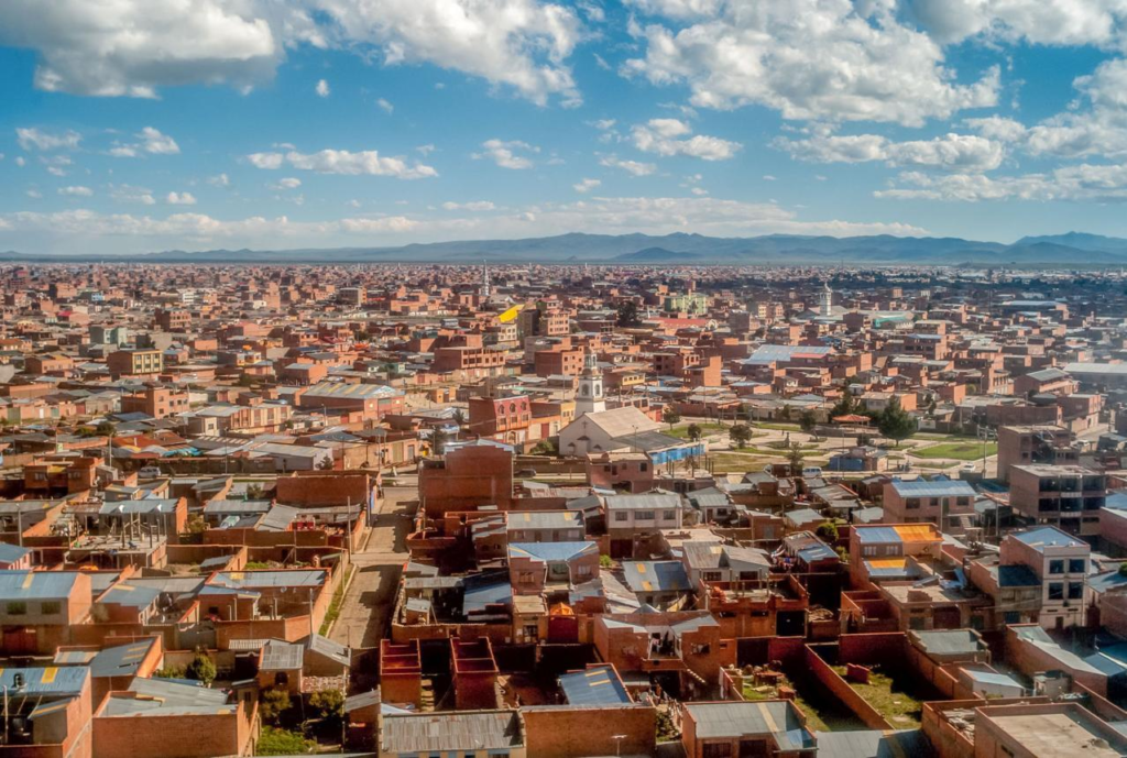 A panoramic aerial view of El Alto showing the cityscape and surrounding Andean plateau in Bolivia.