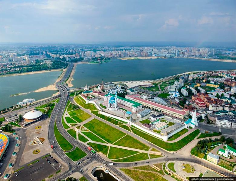 A panoramic aerial view of Kazan showing the cityscape, the Kazan Kremlin, and the Volga River in Russia.